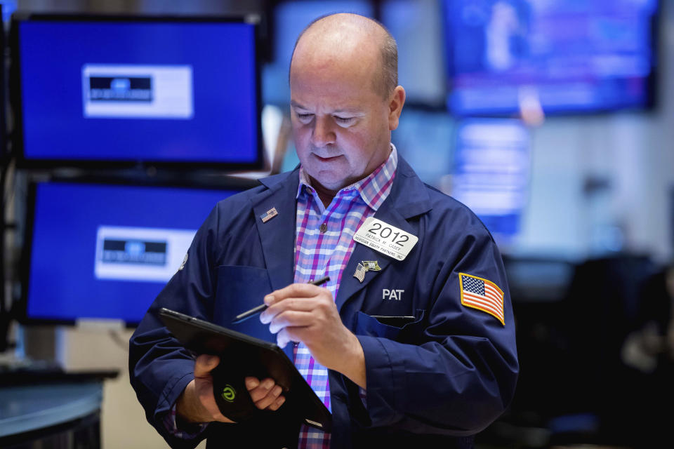 In this photo provided by the New York Stock Exchange, trader Patrick Casey works on the floor of the New York Stock Exchange, Friday, March 4, 2022, in New York. Stocks around the world racked up more losses Friday, as even a gangbusters report on the U.S. jobs market can't pull Wall Street's focus off its worries about the war in Ukraine. (Courtney Crow/New York Stock Exchange via AP)