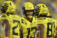 Oregon quarterback Ty Thompson (13) celebrates a touchdown with running back Byron Cardwell (21) and wide receiver Josh Delgado (83) during the second half of an NCAA college football game Saturday, Sept. 10, 2022, in Eugene, Ore. (AP Photo/Andy Nelson)