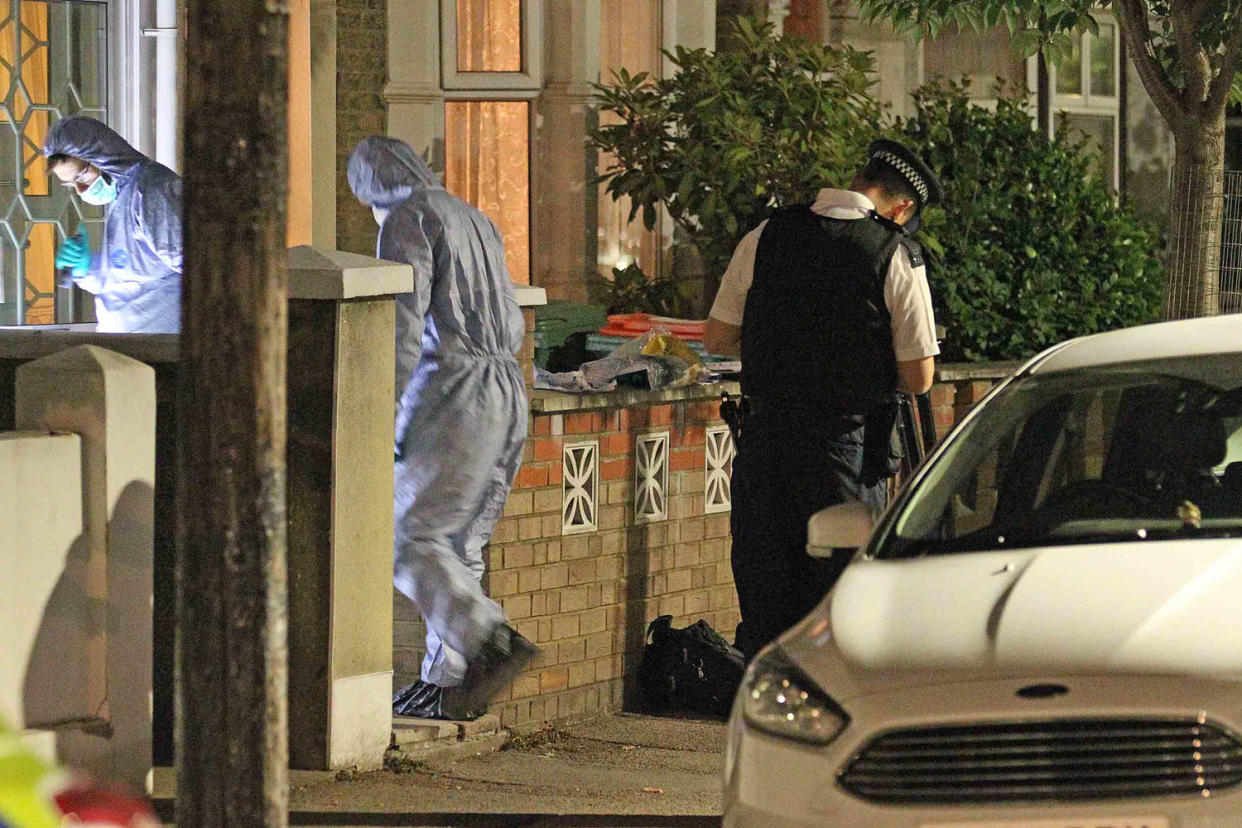 Murder scene: Forensic officers at the former couple's home: Nigel Howard