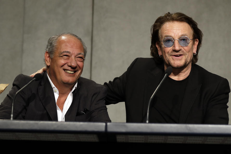 U2 rock band frontman Bono Vox, right, and Jose Maria Del Corral, president of the Scholas Occurrentes charity fundation, talk to reporters during a press conference at the end of a meeting with Pope Francis, at the Vatican, Wednesday, Sept. 19, 2018. (AP Photo/Andrew Medichini)