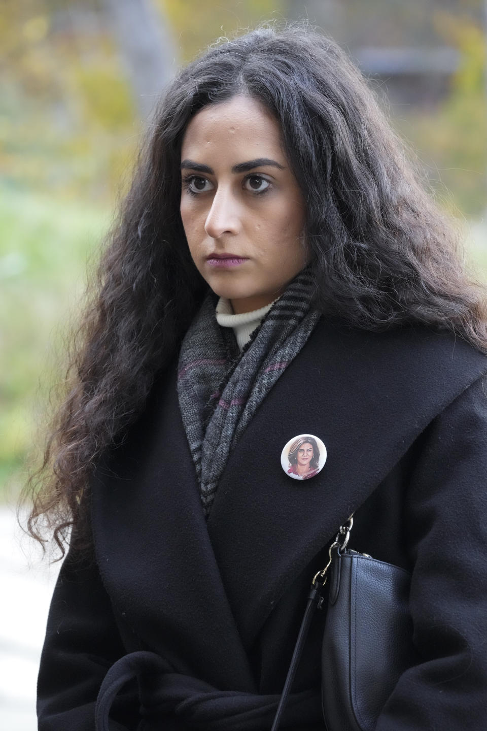 Lina Abu Akleh, niece of fatally shot Al Jazeera journalist Shireen Abu Akleh waits outside the International Criminal Court in The Hague, Netherlands, Tuesday, Dec. 6, 2022, after presenting a letter requesting a formal investigation into the killing. Palestinian officials, Abu Akleh's family and Al Jazeera accuse Israel of intentionally targeting and killing the 51-year-old journalist, a claim Israel denies. (AP Photo/Peter Dejong)