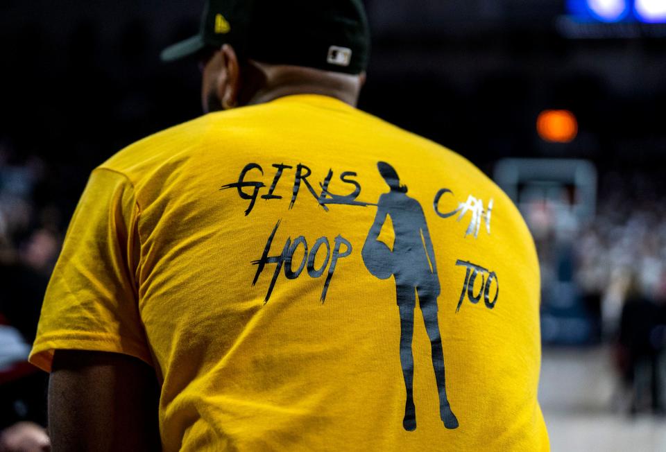 The back of a person's shirt reading "Girls Can Hoop Too" at the Philadelphia Catholic League girls' basketball championship game between Archbishop Carroll and Archbishop Wood in Philadelphia on Monday, Feb. 26, 2024.