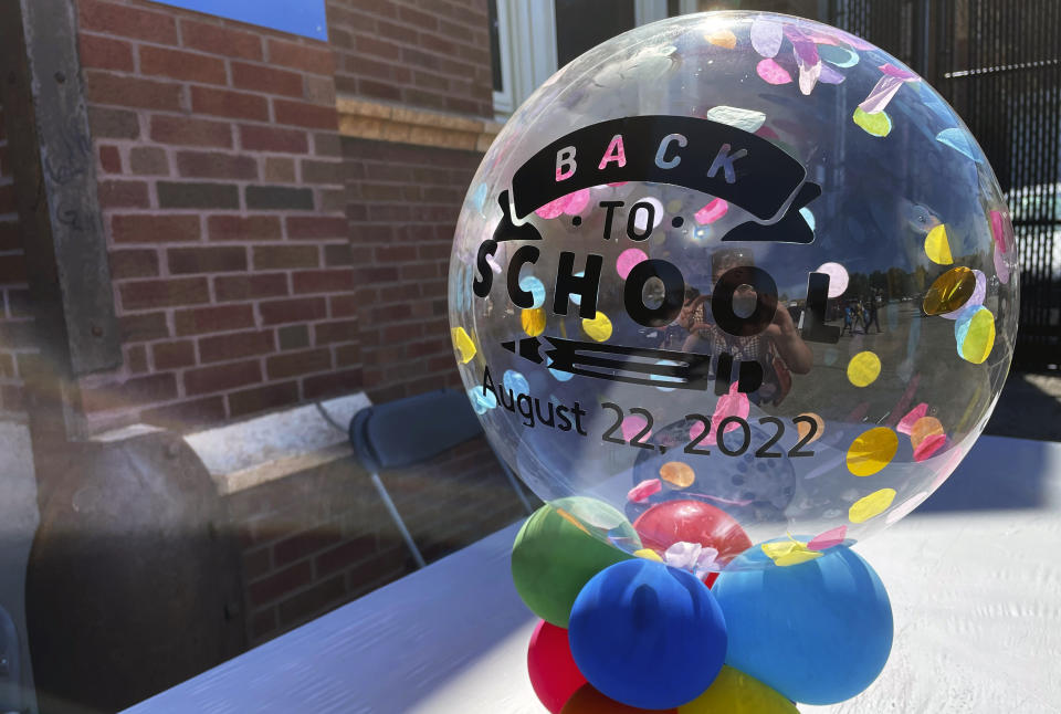 A sign welcomes parents and students as backpacks and school supplies are available at a Chicago Public Schools back-to-school supply giveaway at Theodore Roosevelt High School in Chicago, on July 22, 2022. (AP Photo/Claire Savage)