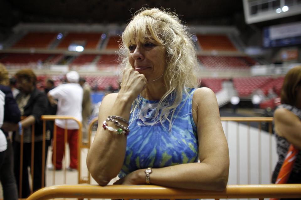 Deborah Iglesias mourns in front of the casket of Cheo Feliciano during his funeral at the San Juan Coliseum in Puerto Rico, Saturday April 19, 2014. Feliciano, a member of the Fania All Stars died in a car crash early Thursday morning when he hit a light post before dawn in the northern suburb of Cupey in San Juan. (AP Photo/Ricardo Arduengo)