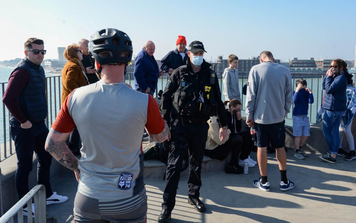 Police officers reminded people of coronavirus restrictions as they gathered to wave of HMS Queen Elizabeth