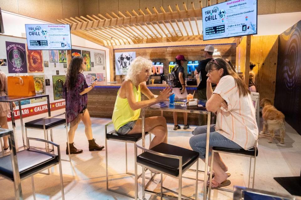 Victoria Derr, center, has a blue raspberry slushie with her friend on Tuesday inside the California Cannabis Exhibit during the California State Fair in Sacramento. The Big Chill sold slushies infused with cannabidiol, commonly referred to as CBD.