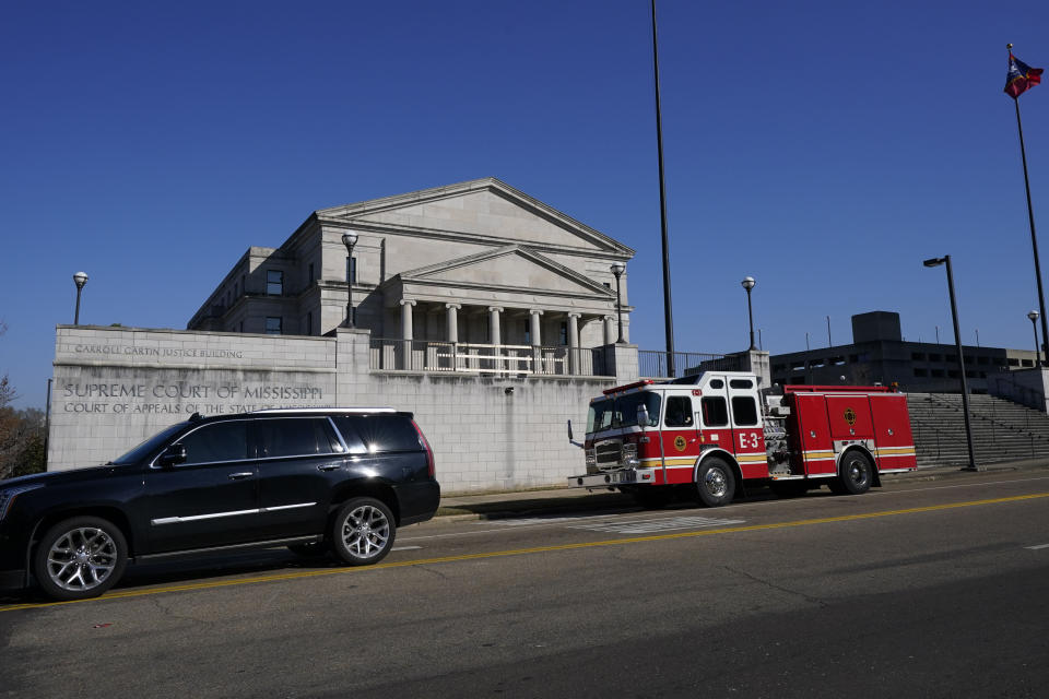 A City of Jackson fire truck rolls past the Mississippi Supreme Court in response to bomb threats at both the Carroll Gartin Justice Building which houses the state supreme and appellate courts, and the Mississippi State Capitol, Thursday morning, Jan. 4, 2024, in Jackson, Miss. The police dealt with the second consecutive day of threats. (AP Photo/Rogelio V. Solis)