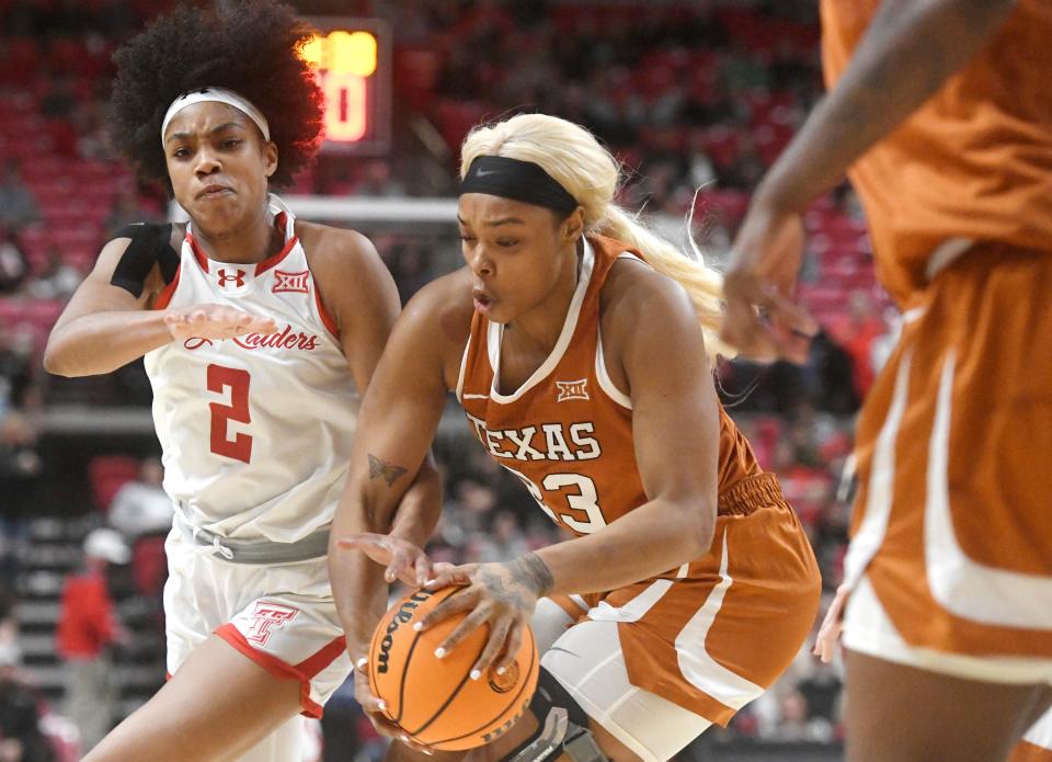 Texas forward Aaliyah Moore works for space against Texas Tech guard Kilah Freelon during their Jan. 3 game in Lubbock. Moore made her first start Saturday since her ACL injury in December 2022 took her out for the rest of last season.