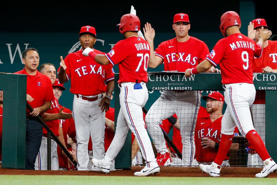 Texas Rangers third baseman Ezequiel Duran (70) is congratulated at the dugout after hitting a three-run home run during the second inning against the Detroit Tigers at Globe Life Field in Arlington, Texas, on Friday, Aug. 26, 2022.