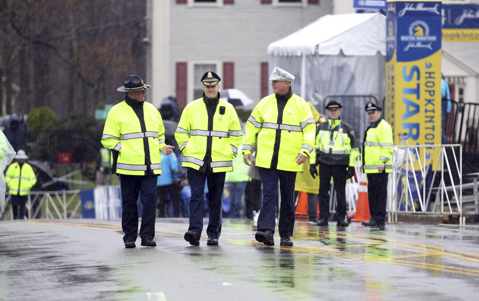 Massachusetts State Police walk the starting area of the 123rd Boston Marathon on Monday, April 15, 2019, in Hopkinton, Mass. (AP Photo/Stew Milne)
