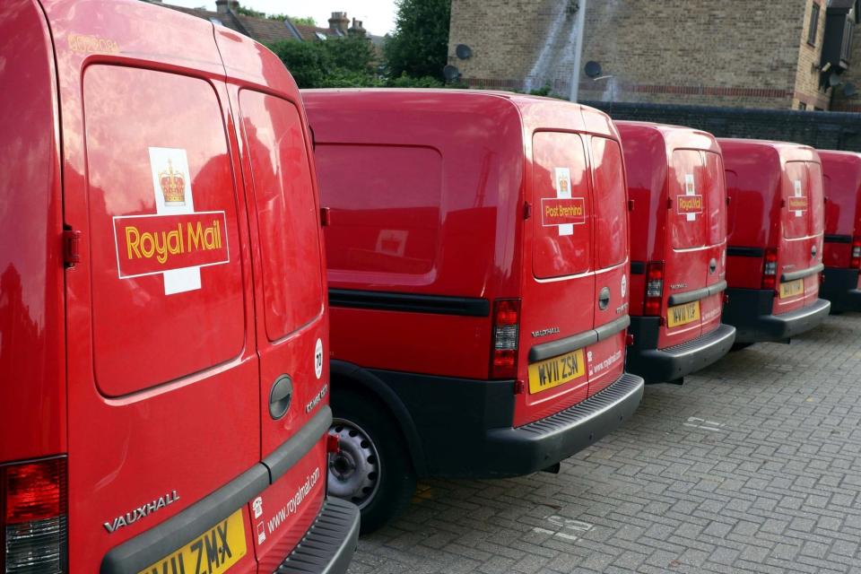 <p>Royal Mail vans are parked in the Leytonstone post office depot in London</p> (REUTERS)