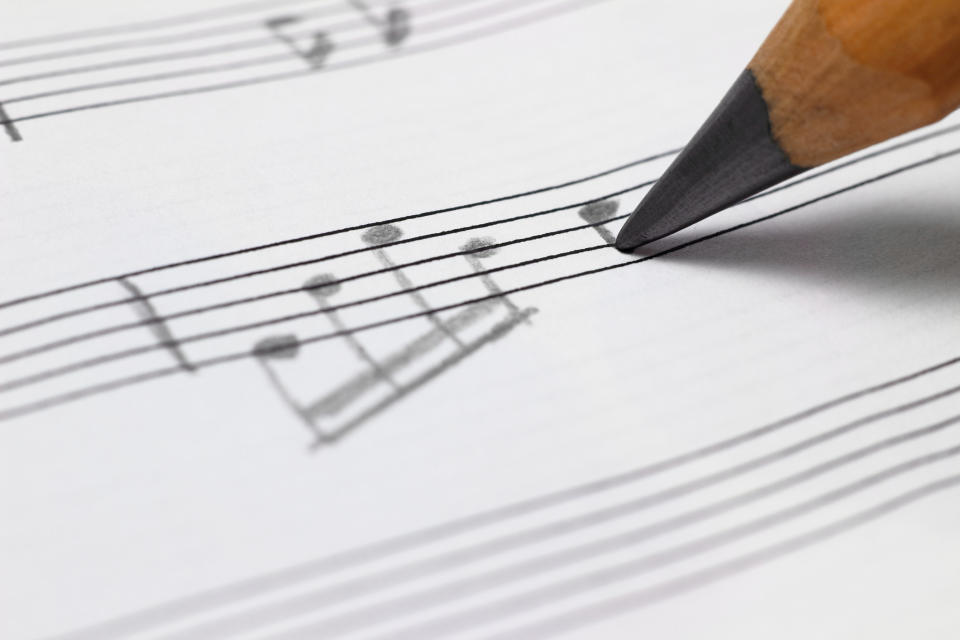 pencil writing down music notes