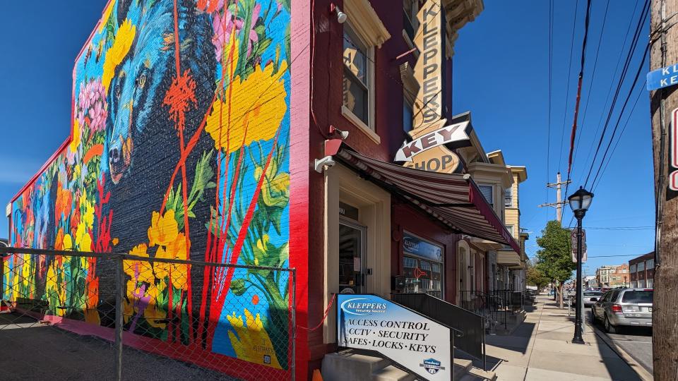 A colorful mural covers the side of Klepper's Security Source at 117 East King Street on April 17, 2024. An early sign above the door traces the relocation of the business to the site in 1940.