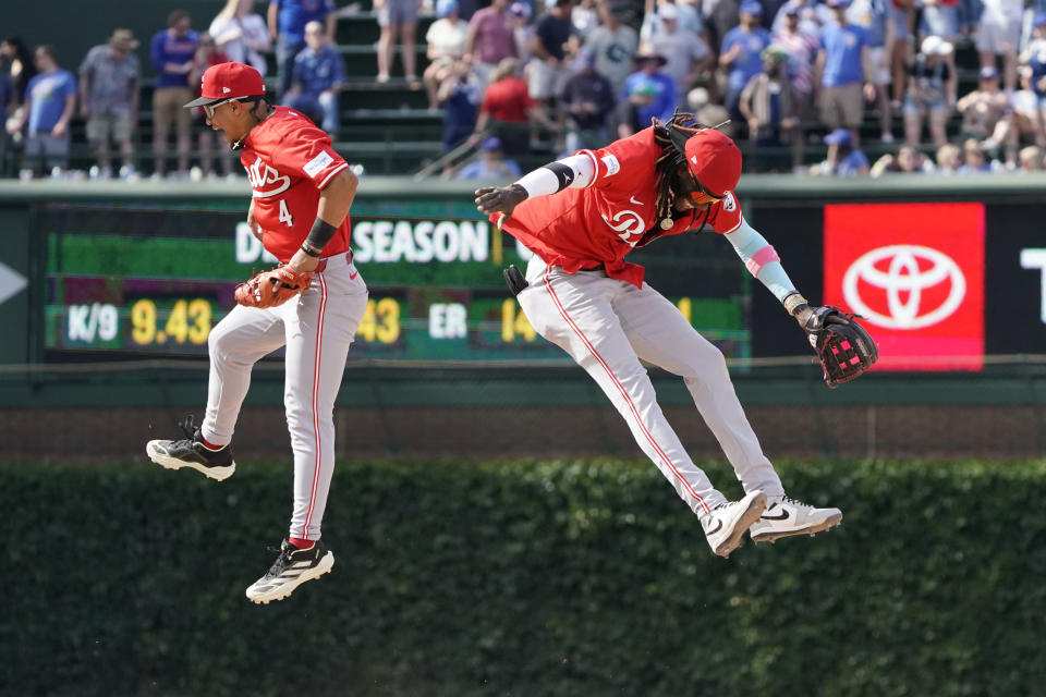 Cincinnati Reds second baseman Santiago Espinal, left, and shortstop Elly De La Cruz, right, celebrate after their win over the Chicago Cubs in a baseball game Friday, May 31, 2024, in Chicago. (AP Photo/David Banks)