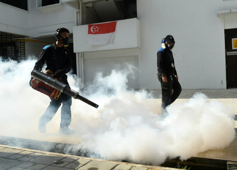 Pest control staff fumigate at Macpherson housing estate in Singapore, on August 31, 2016