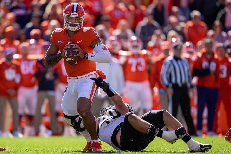 Clemson quarterback D.J. Uiagalelei breaks a tackle from Wake Forest defensive lineman Rondell Bothroyd during the first quarter at Clemson Memorial Stadium on November 20, 2021 in Clemson, South Carolina.