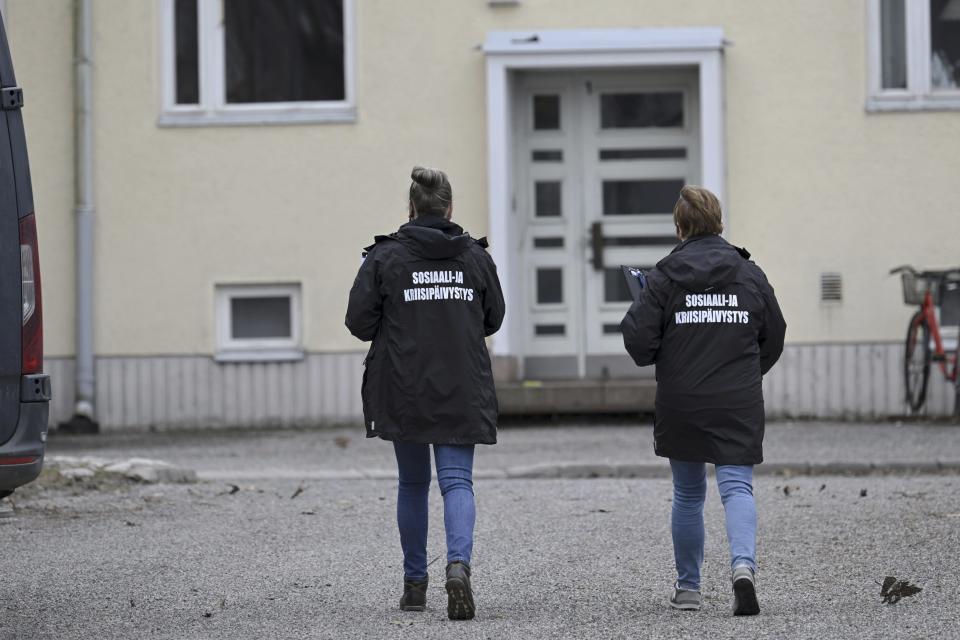 Two members of the social and crisis emergency services arrive at Viertola comprehensive school, in Vantaa, Finland, Tuesday, April 2, 2024. Police in Finland say a 12-year-old student has opened fire at a secondary school in southern Finland and wounded three other students. The suspect was later arrested. Heavily armed police on Tuesday cordoned off the lower secondary school, with some 800 students, in the city of Vantaa, just outside the capital, Helsinki, after receiving a call about a shooting incident at 09:08 a.m. Police said both the suspect and the wounded were 12 years old. (Markku Ulander/Lehtikuva via AP)