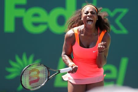 Serena Williams celebrates after winning a point against Sabine Lisicki (not pictured) on day ten of the Miami Open at Crandon Park Tennis Center. Williams won 7-6 (4), 1-6, 6-3. Mandatory Credit: Geoff Burke-USA TODAY