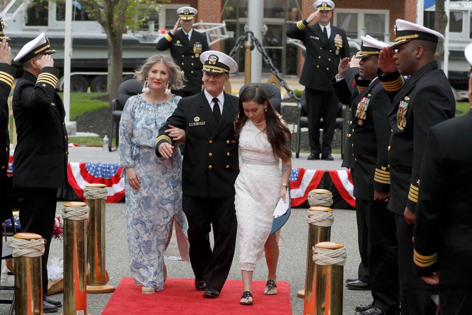 Former Naval Weapons Station Earle Commander Captain Edward L. Callahan is joined by his wife Krista and daughter Taylor as he is "Piped ashore" during the Change of Command ceremony in Colts Neck Friday, April 21, 2023.