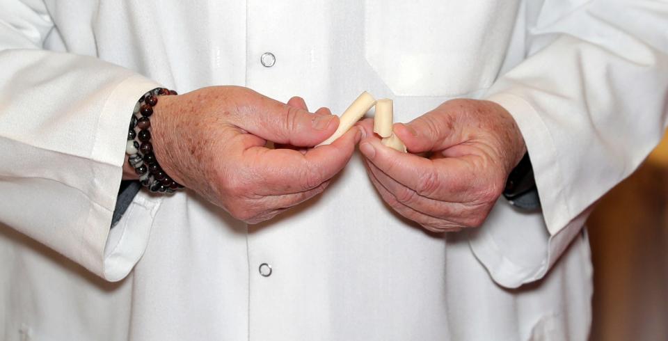 Judge Cathy Strange tests a Gruyère cheese Tuesday during the 2024 World Championship Cheese Contest at Monona Terrace Community and Convention Center in Madison.