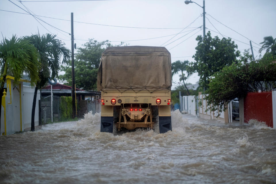 <p>A Puerto Rico National Guard truck drives through a flooded street searching for people to be rescued in the aftermath of Hurricane Fiona in Salinas, Puerto Rico September 19, 2022. REUTERS/Ricardo Arduengo</p> 