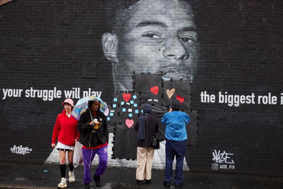 Passersby attach messages of support for Marcus Rashford after a mural of him in Manchester was defaced.