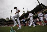 England's captain Alastair Cook (front) walks onto the ground with his team at the start of the first day of the fifth Ashes cricket test match against Australia in Sydney January 3, 2014. REUTERS/David Gray