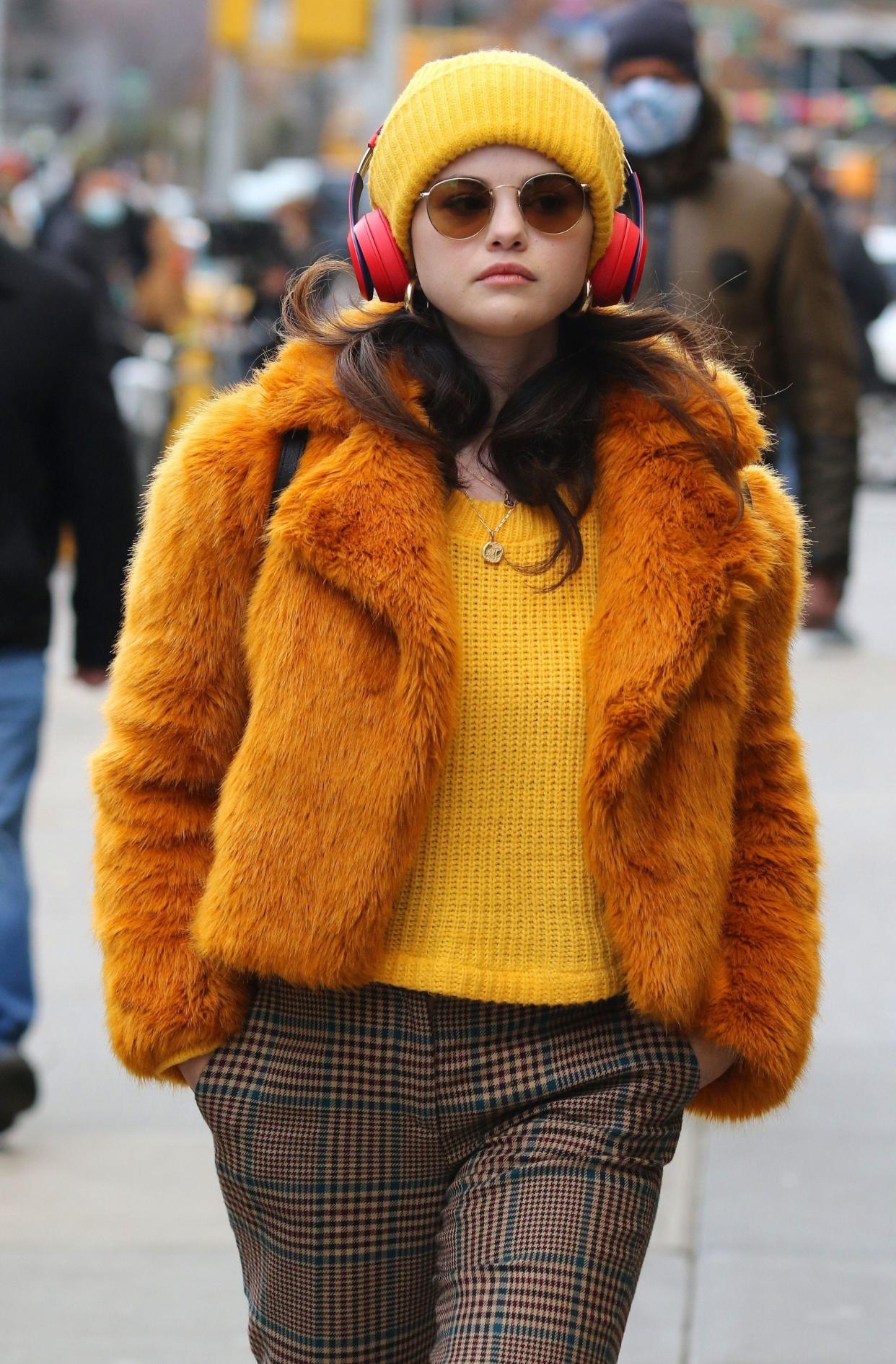 Selena Gomez sports sunglasses and beats headphones in stylish colorful clothes while filming for Hulu's upcoming comedy series, "Only Murders In The Building" in New York City on Monday, Dec. 7, 2020. The show stars Gomez, Martin Short and Steve Martin.