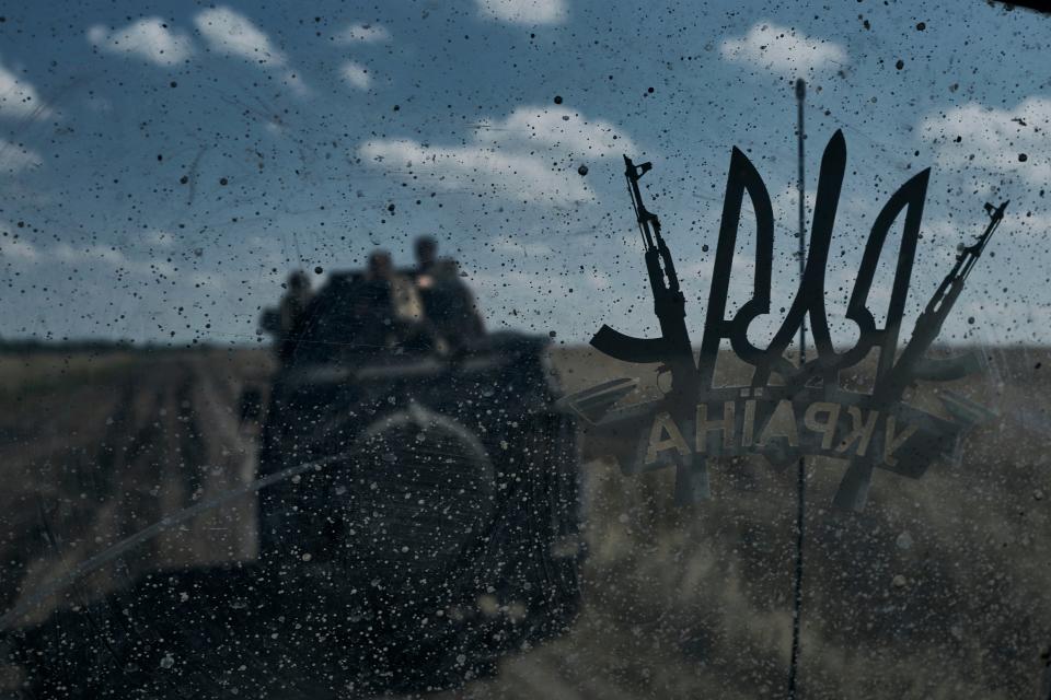 Ukrainian soldiers ride an APC at the front line near Bakhmut, Donetsk region (AP)