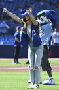 Canadian Olympian Penny Oleksiak throws out the ceremonial first pitch before the start of a baseball game between the Toronto Blue Jays and the Minnesota Twins in Toronto on Saturday, Sept. 18, 2021. (Jon Blacker/The Canadian Press via AP)