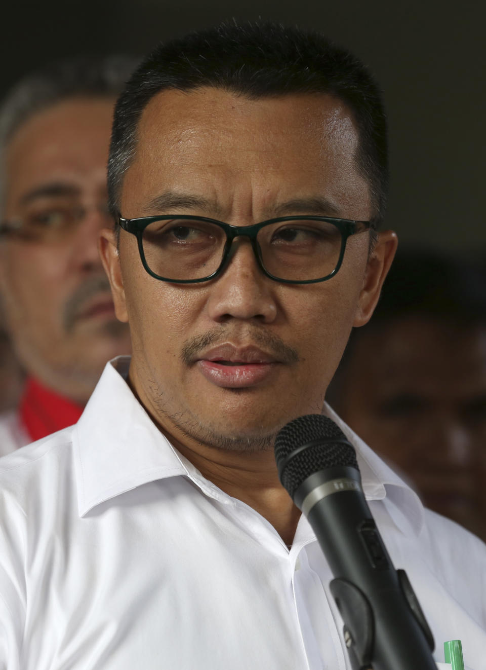 Indonesian Youth and Sports Minister Imam Nahrawi speaks to the media during a press conference in Jakarta, Indonesia, Thursday, Sept. 19, 2019. Nahrawi has stepped down from his position after being named a bribery suspect by the country's anti-graft commission. (AP Photo/Tatan Syuflana)