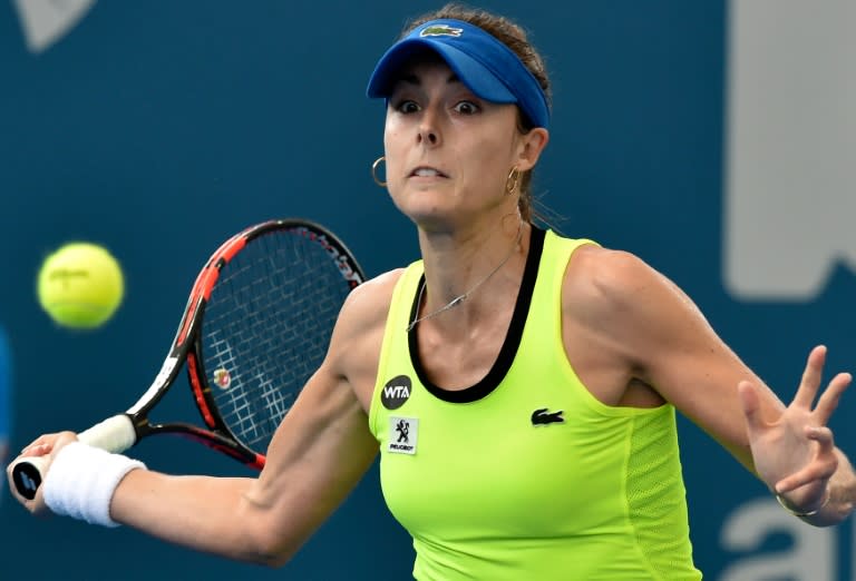 France' Alize Cornet hits a return against Russia's Anastasia Pavlyuchenkova during their match on the third day of the Brisbane International on January 5, 2016