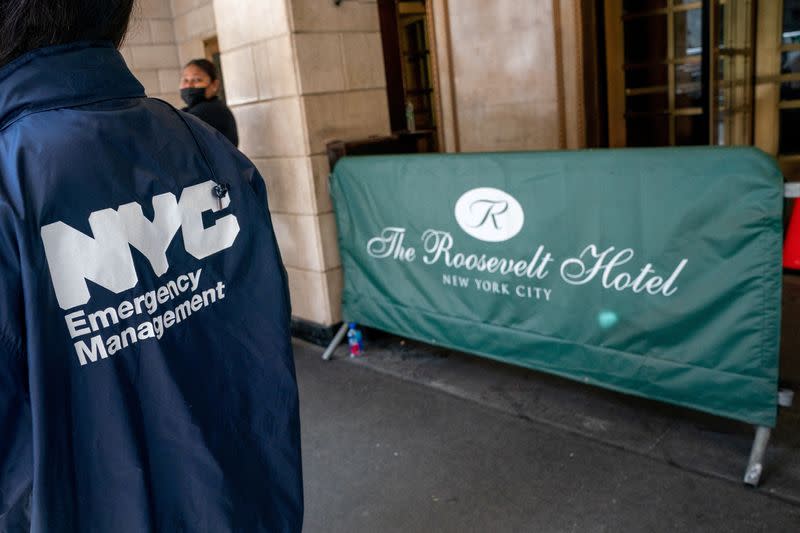 FILE PHOTO: A emergency management employee stands outside of the Roosevelt Hotel, where asylum-seekers are currently being housed, in New York