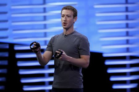 Facebook CEO Mark Zuckerberg holds a pair of the touch controllers for the Oculus Rift virtual reality headsets on stage during the Facebook F8 conference in San Francisco, California April 12, 2016. REUTERS/Stephen Lam