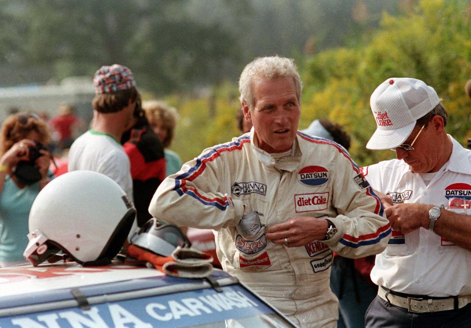 Actor-turned-race car driver Paul Newman is seen in his racing gear at Lime Rock Park racetrack in Lime Rock, Conn., in September 1983. (AP Photo)