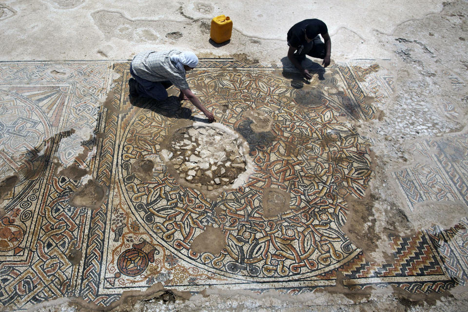 Archaeologists of the Israeli Antiquities Authority work on a 1500-year-old Byzantine era mosaic floor near Kibbutz Beit Kama in the Israeli Negev on May 12 2013. (MENAHEM KAHANA/AFP/Getty Images)  <a href="http://www.huffingtonpost.com/2013/05/13/byzantine-mosaics-southern-israel_n_3272484.html?utm_hp_ref=unearthed" target="_blank">Read more here</a>