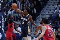 New Orleans Pelicans forward Herbert Jones (5) pulls down a rebound over Toronto Raptors forward Chris Boucher (25) in the first half of an NBA basketball game in New Orleans, Wednesday, Nov. 30, 2022. (AP Photo/Gerald Herbert)