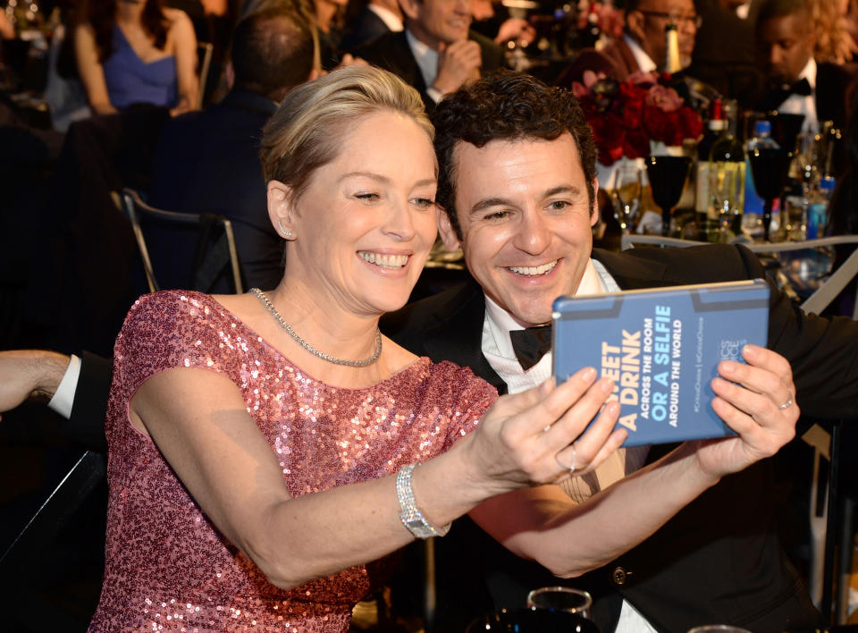 SANTA MONICA, CA - JANUARY 17: Actress Sharon Stone (L) takes a selfie with actor Fred Savage during the 21st Annual Critics' Choice Awards at Barker Hangar on January 17, 2016 in Santa Monica, California. (Photo by Kevin Mazur/WireImage)