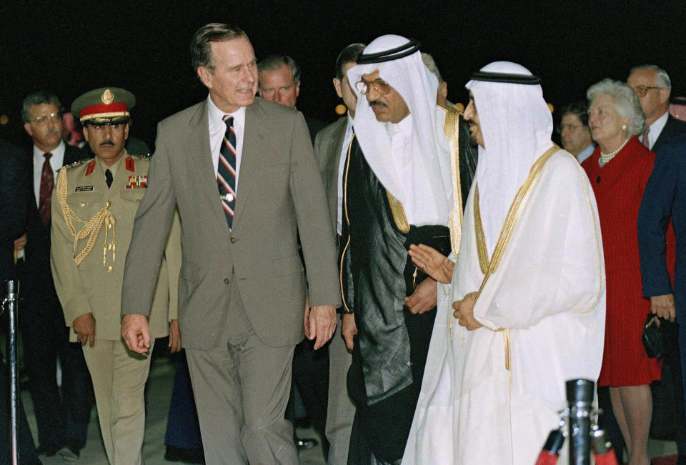 FILE - In this Nov. 21, 1990, file photo, President George H.W. Bush is greeted by King Fahd on his arrival in Jeddah, Saudi Arabia. At right is first lady Barbara Bush. Bush has died at age 94. Family spokesman Jim McGrath says Bush died shortly after 10 p.m. Friday, Nov. 30, 2018, about eight months after the death of his wife, Barbara Bush. (AP Photo/J. Scott Applewhite, File)