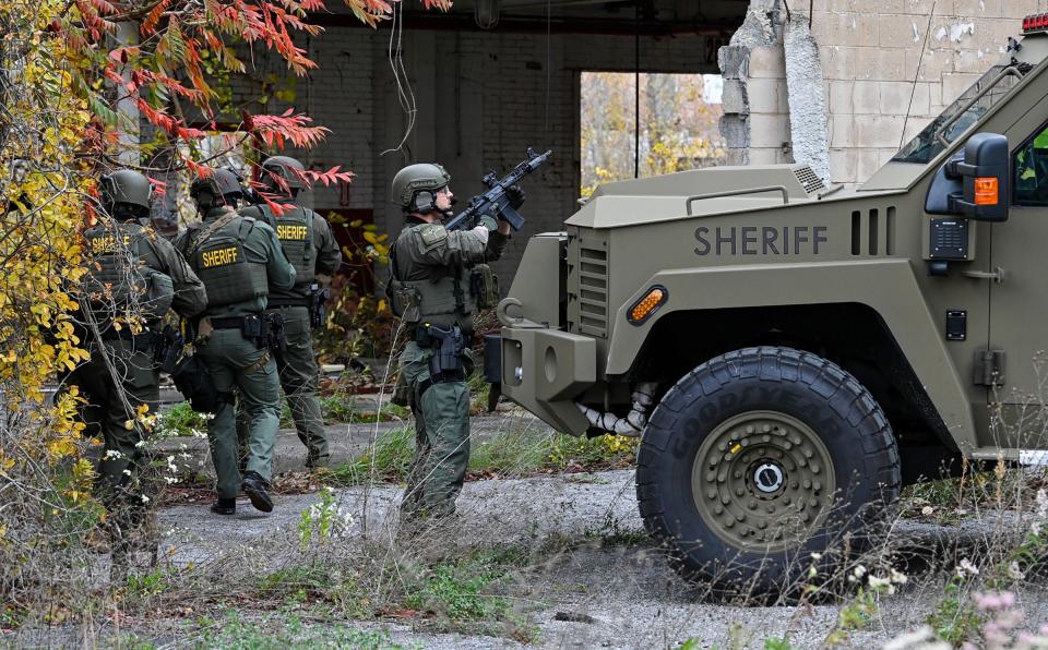 Frederick County Sheriff's SWAT Team members check vacant buildings Saturday at the former Garden State Tannery near Williamsport for Pedro Argote, the suspect in the killing of Washington County Circuit Court Judge Andrew Wilkinson.