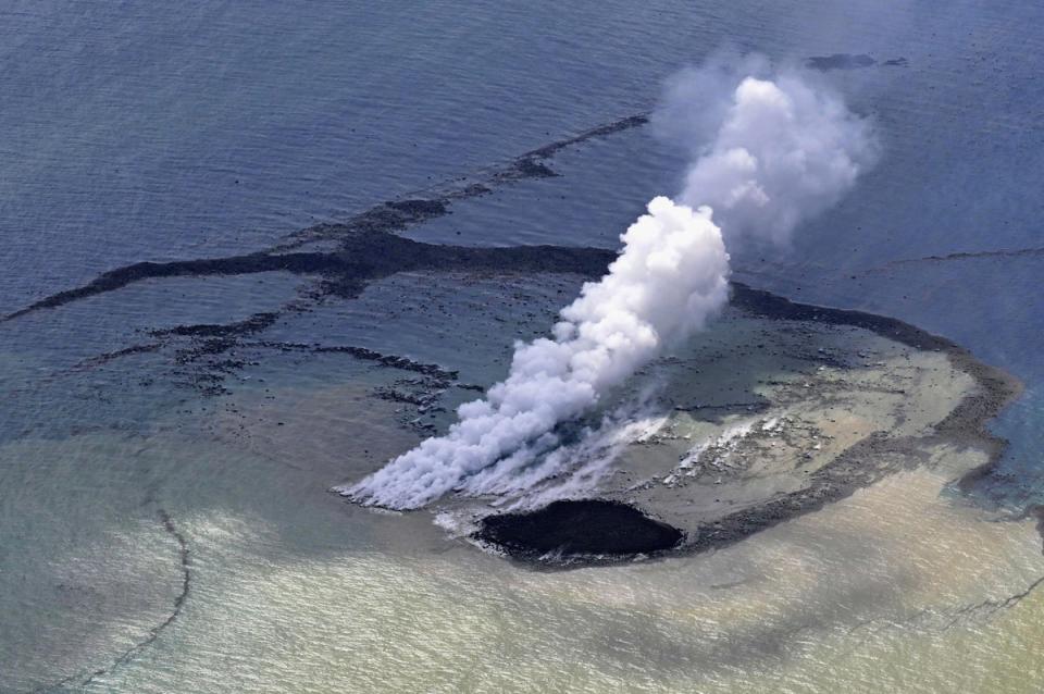 The new island formed by erupted rock (AP)