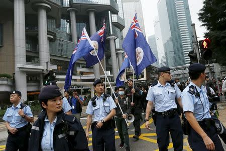 Demonstrators hold Hong Kong's old colonial-era flags during a protest over the disappearance of booksellers, in Hong Kong, China January 10, 2016. REUTERS/Tyrone Siu