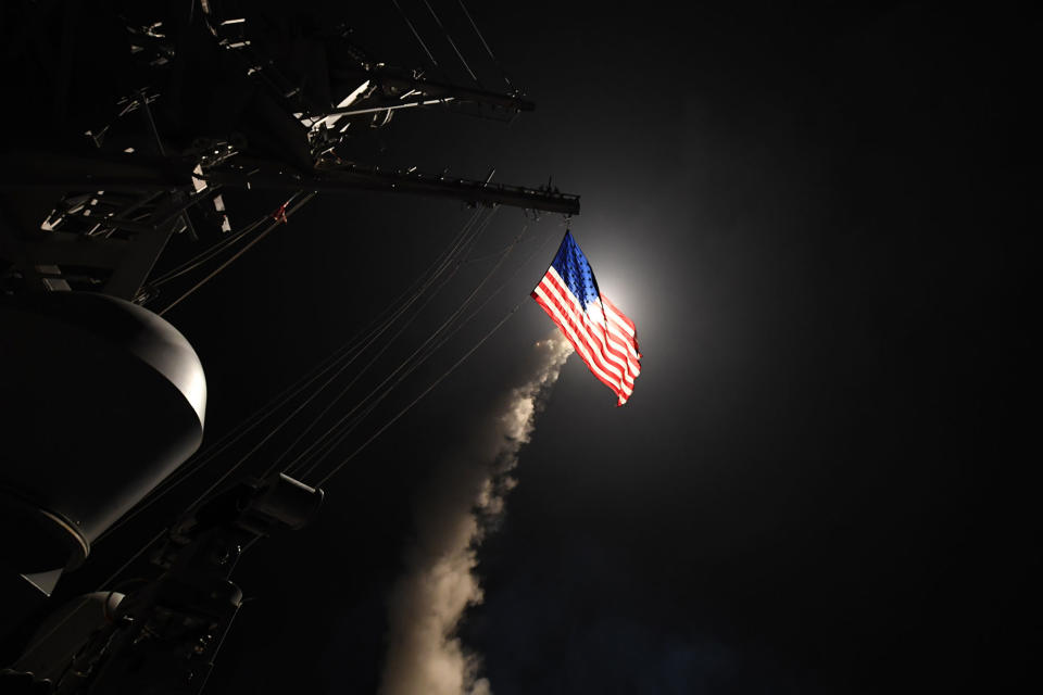 <p>APR. 7, 2017 – The guided-missile destroyer USS Porter fires a Tomahawk land attack missile from the Mediterranean Sea. The USS Porter was one of two destroyers that fired a total of 59 cruise missiles at a Syrian military airfield in retaliation for a chemical attack that killed scores of civilians this week. The attack was the first direct U.S. assault on Syria and the government of President Bashar al-Assad in the six-year war there. (Photo: Ford Williams/U.S. Navy via Getty Images) </p>