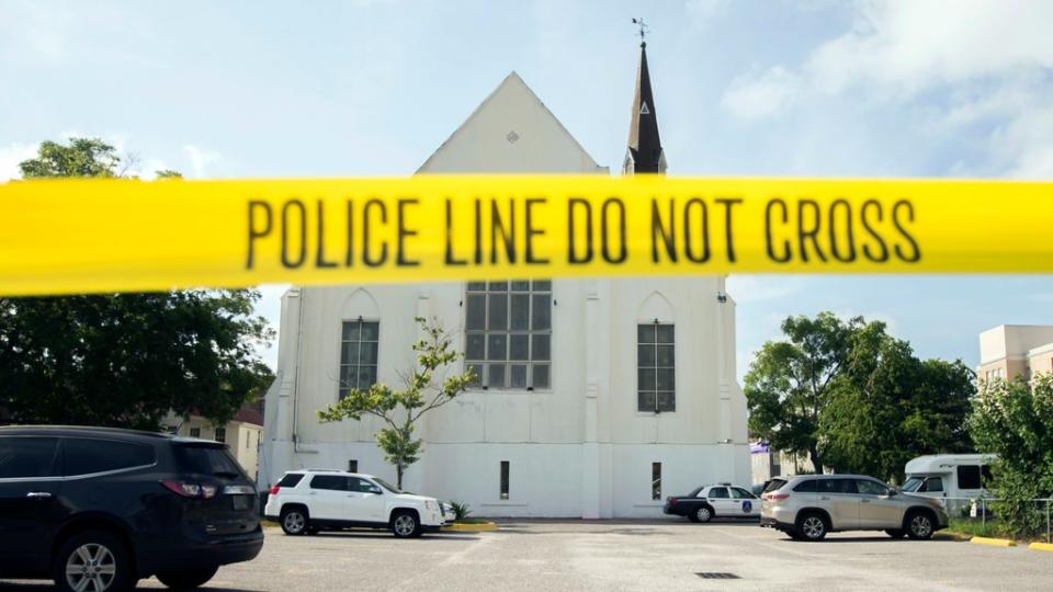 Police tape surrounds the parking lot behind the AME Emanuel Church as FBI forensic experts work the crime scene, in Charleston, Soth Carolina ((AP Photo/Stephen B. Morton, File))