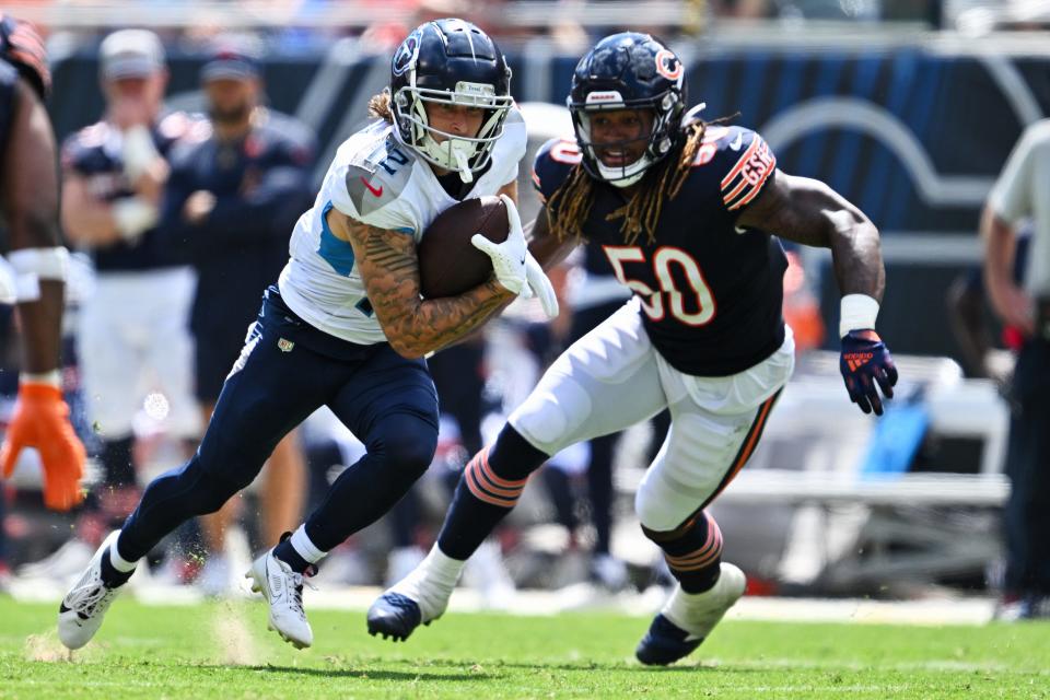 Tennessee Titans wide receiver Mason Kinsey (12) runs after a reception while being pursued by Chicago Bears linebacker Buddy Johnson (50) in the second half at Soldier Field.