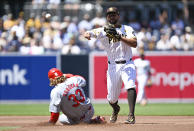 San Diego Padres second baseman Xander Bogaerts (2) throws over St. Louis Cardinals' Brendan Donovan (33) as he turns a double play during the first inning of a baseball game, Wednesday, April 3, 2024, in San Diego. (AP Photo/Denis Poroy)