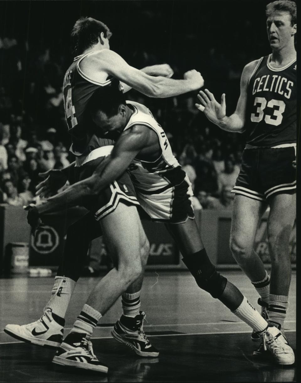 Boston's Danny Ainge (left) and Milwaukee's Sidney Moncriel tangled during the Eastern Conference semifinals in 1987. The Bucks went on to defeat the Celtics, 121-111.