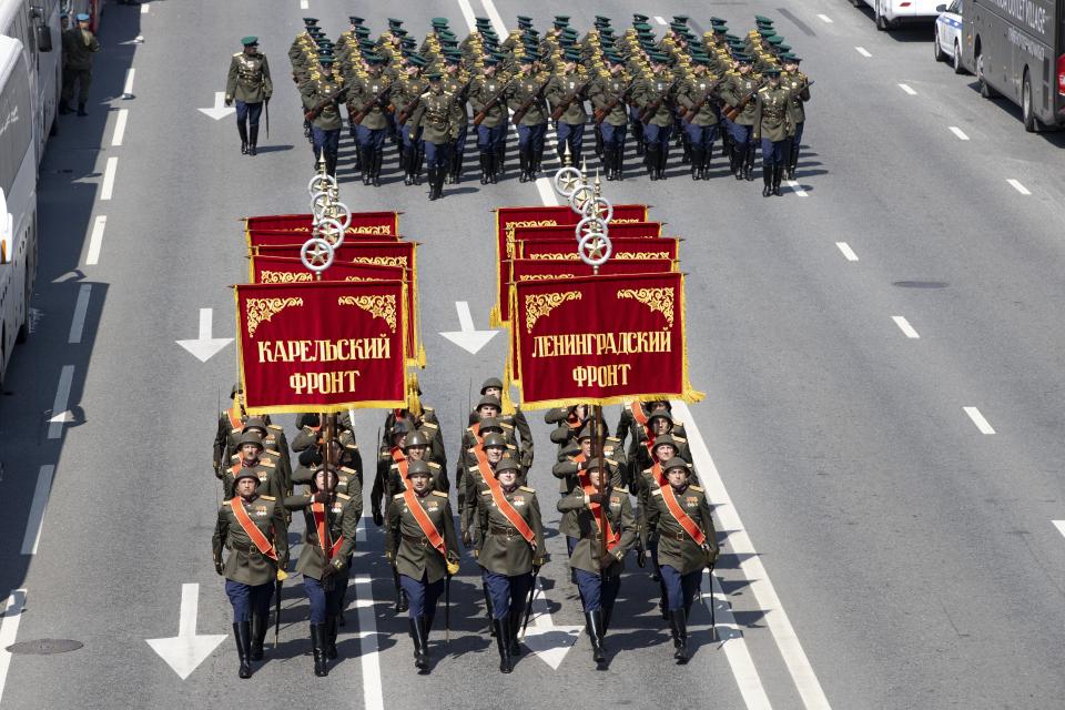 FILE - In this file photo taken on Saturday, June 20, 2020, Russian soldiers wearing WWII-era uniforms march toward Red Square to attend a dress rehearsal for the Victory Day military parade in Moscow, Russia. A massive military parade that was postponed by the coronavirus will roll through Red Square this week to celebrate the 75th anniversary of the end of World War II in Europe, even though Russia is continuing to register a steady rise in infections. (AP Photo/Alexander Zemlianichenko, File)