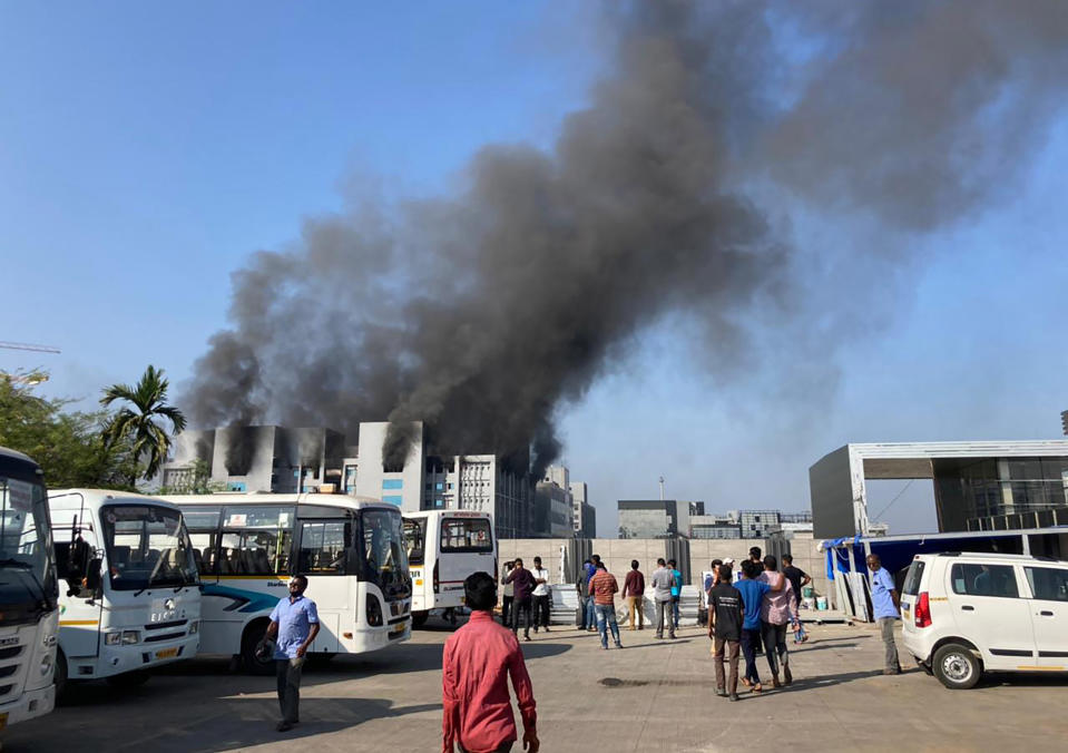 Smoke rises from the Serum Institute of India, the world's largest vaccine maker that is manufacturing the AstraZeneca/Oxford University vaccine for the coronavirus, in Pune, India, Thursday, Jan. 21, 2021. (AP Photo/Rafiq Maqbool)