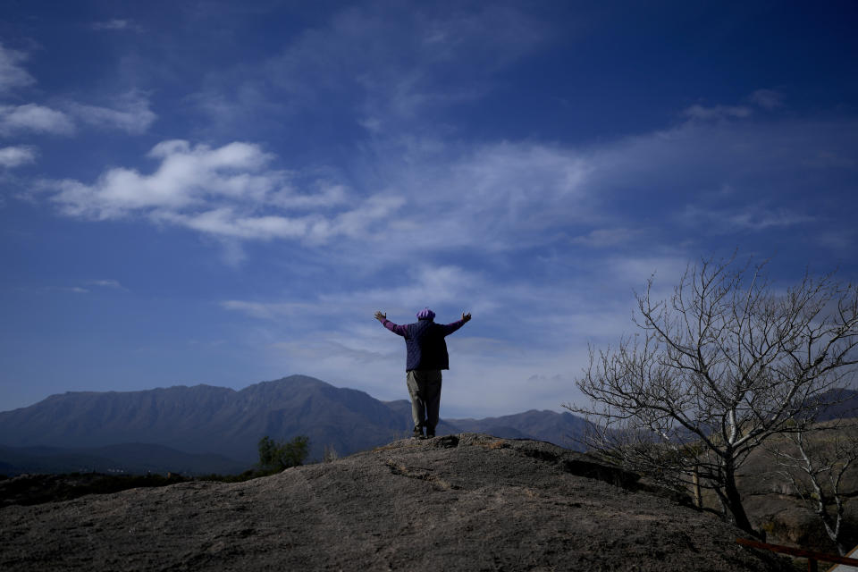 Jorge Hector Roldan, better known as Larry, stands with his arms spread out, facing the Uritorco mountains in Capilla del Monte, Cordoba, Argentina, Tuesday, July 18, 2023. In the pope’s homeland of Argentina, Catholics have been renouncing the faith and joining the growing ranks of the religiously unaffiliated. Commonly known as the “nones,” they describe themselves as atheists, agnostics, spiritual but not religious, or simply: “nothing in particular.” (AP Photo/Natacha Pisarenko)